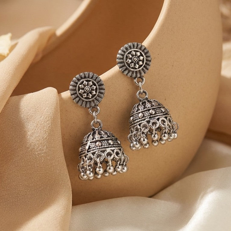 A soft whisper of tradition in a minimal form, this piece captures the charm of classic jhumka design in a delicate, everyday silhouette, The oxidized finish adds a vintage soul while the tiny ghungroo details bring subtle movement and grace
