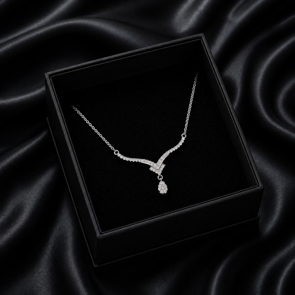 Inspired by the crisp, sparkling beauty of high-mountain peaks, the Alpine Drop Necklace is a masterclass in understated luxury. This piece features a graceful, V-shaped "Alpine" silhouette that leads the eye to a brilliant teardrop focal point, creating an elegant lengthening effect that elevates any neckline.