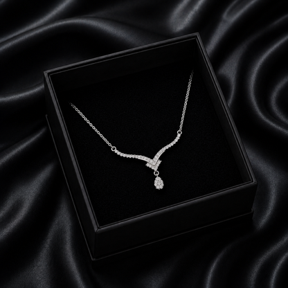 Inspired by the crisp, sparkling beauty of high-mountain peaks, the Alpine Drop Necklace is a masterclass in understated luxury. This piece features a graceful, V-shaped "Alpine" silhouette that leads the eye to a brilliant teardrop focal point, creating an elegant lengthening effect that elevates any neckline.