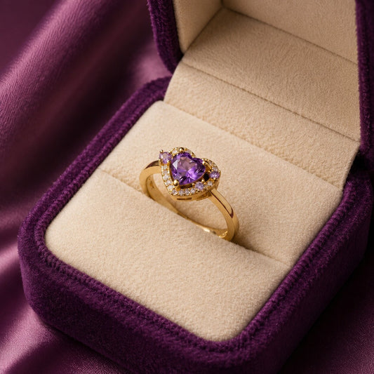 A royal touch of violet brilliance, this ring features a heart-shaped purple centerpiece framed with delicate crystal accents. Its romantic heart silhouette and polished gold-tone finish create a dreamy statement that feels elegant, feminine, and beautifully regal.