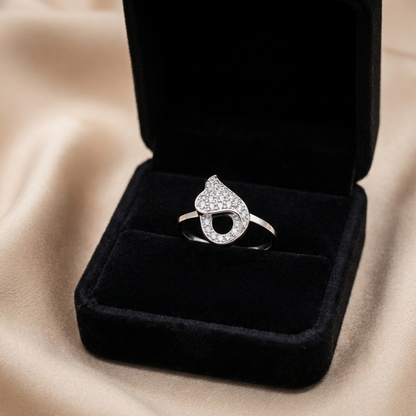 A romantic statement ring defined by a fluid heart-inspired silhouette and a soft cascade of shimmering zircon stones. The Amoria Flow Ring is designed to symbolize effortless love and graceful movement—where curves meet sparkle in perfect harmony. Elegant yet expressive, it adds warmth and charm to every gesture.