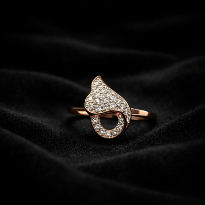 A romantic statement ring defined by a fluid heart-inspired silhouette and a soft cascade of shimmering zircon stones. The Amoria Flow Ring is designed to symbolize effortless love and graceful movement—where curves meet sparkle in perfect harmony. Elegant yet expressive, it adds warmth and charm to every gesture.