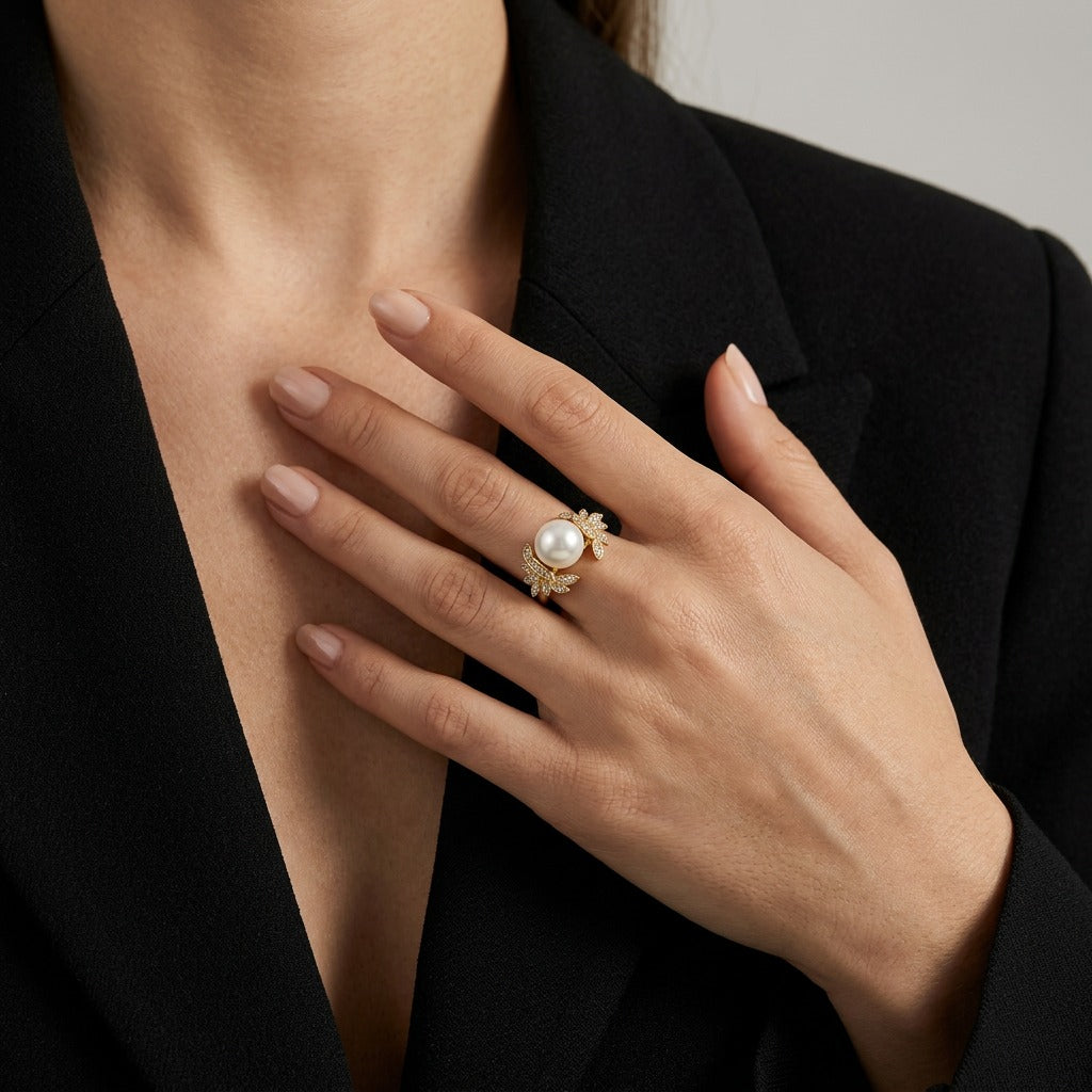 Unveil the essence of goddess-like beauty with the Artemis Bloom Ring. This enchanting piece features a majestic center pearl cradled by intricate golden petals, capturing the spirit of a flower in mid-bloom for a look that is both regal and timeless.