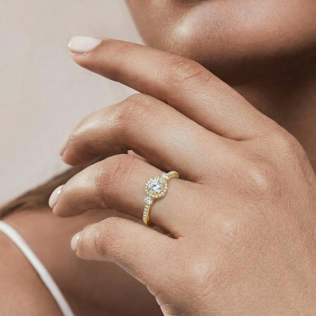 A luminous sparkle framed in timeless elegance, this ring captures the beauty of celestial brilliance with its radiant halo centerpiece and delicate crystal accents. The refined silhouette creates a graceful look that feels both romantic and luxurious.