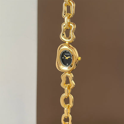 A fluid expression of elegance, where sculpted links flow seamlessly into a refined oval dial, creating a look that feels both modern and timeless. Designed to sit gracefully on the wrist, this piece blends soft femininity with a bold, polished presence.