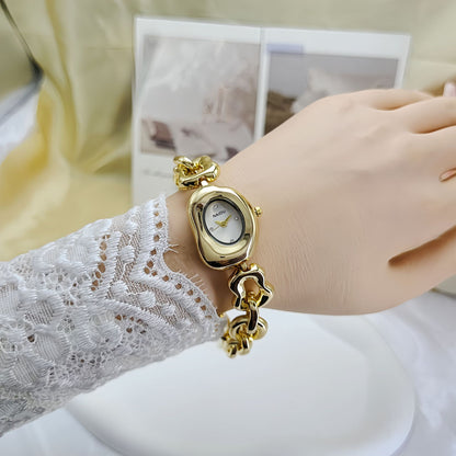 A fluid expression of elegance, where sculpted links flow seamlessly into a refined oval dial, creating a look that feels both modern and timeless. Designed to sit gracefully on the wrist, this piece blends soft femininity with a bold, polished presence.