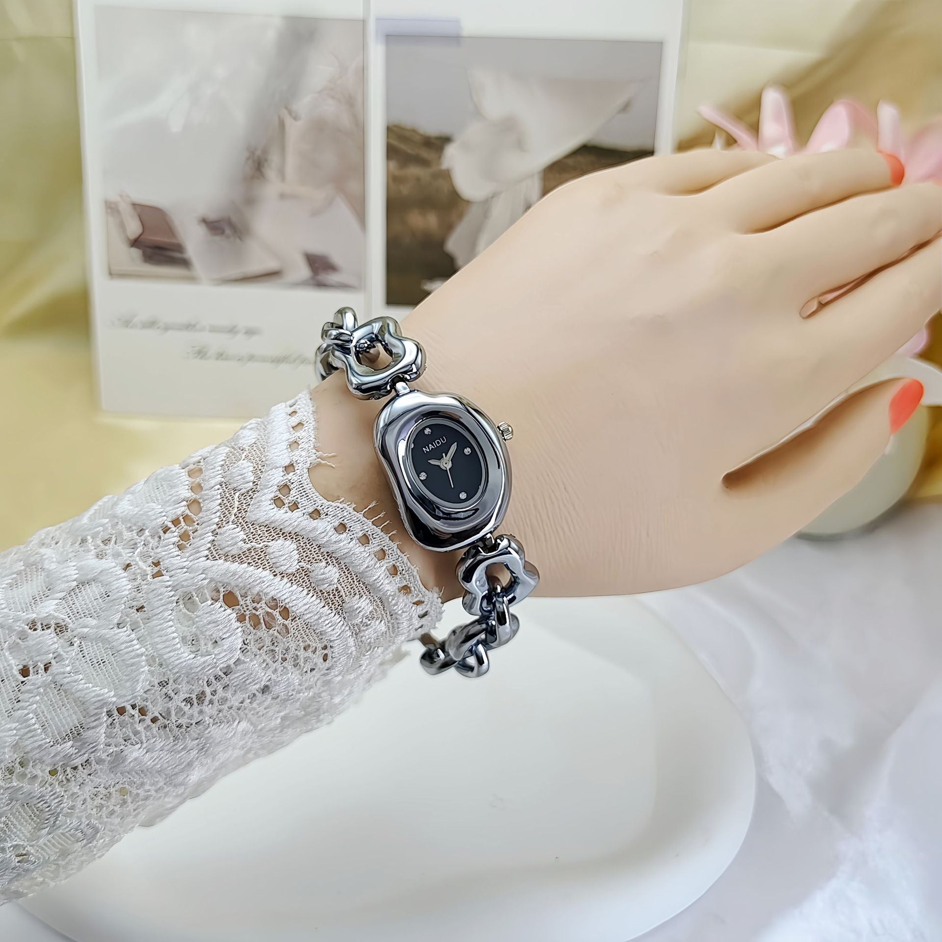 A fluid expression of elegance, where sculpted links flow seamlessly into a refined oval dial, creating a look that feels both modern and timeless. Designed to sit gracefully on the wrist, this piece blends soft femininity with a bold, polished presence.