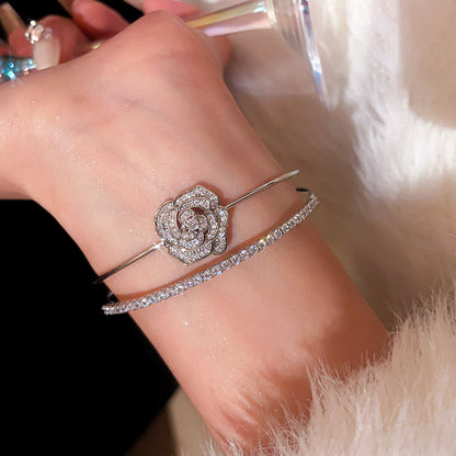 A classic silver-glow centerpiece wrapped in a camellia-bloom shimmer frame—this bracelet looks like quiet luxury, finished with just the right sparkle. Camelia Lumi Bracelet is the kind of elegant piece that upgrades every outfit instantly.

