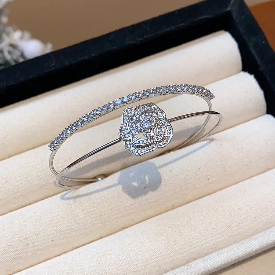 A classic silver-glow centerpiece wrapped in a camellia-bloom shimmer frame—this bracelet looks like quiet luxury, finished with just the right sparkle. Camelia Lumi Bracelet is the kind of elegant piece that upgrades every outfit instantly.

