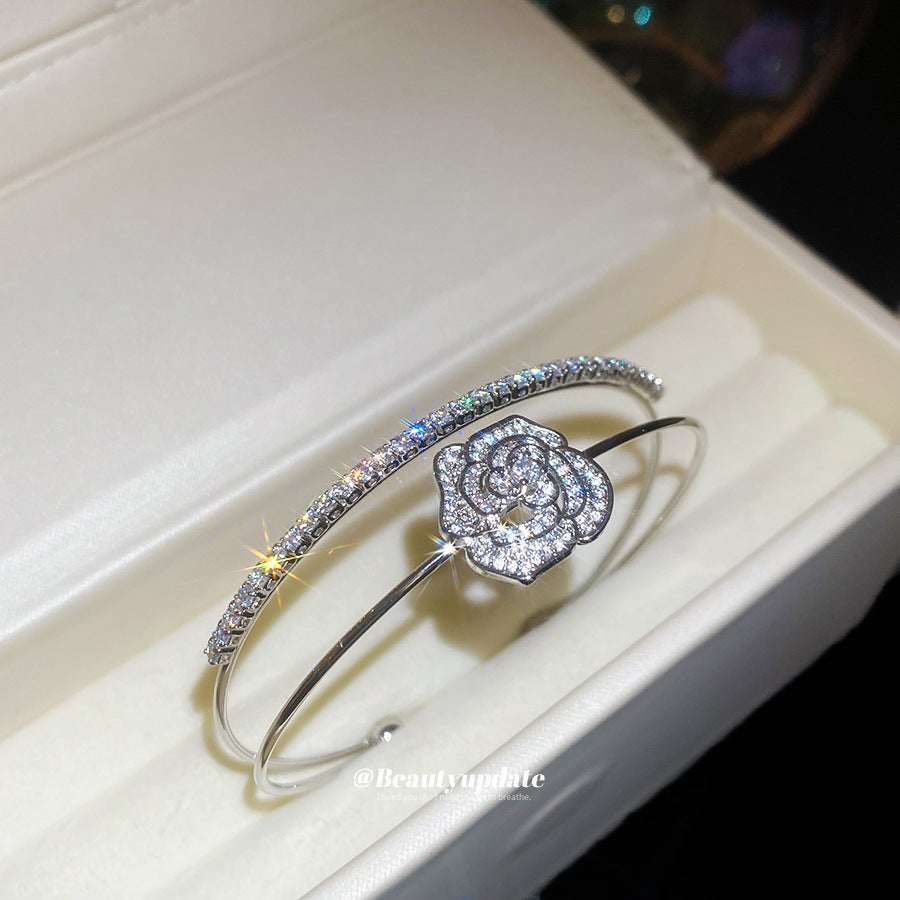A classic silver-glow centerpiece wrapped in a camellia-bloom shimmer frame—this bracelet looks like quiet luxury, finished with just the right sparkle. Camelia Lumi Bracelet is the kind of elegant piece that upgrades every outfit instantly.

