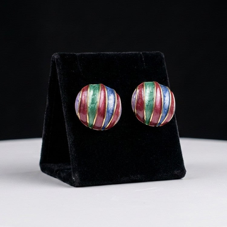 A playful celebration of color and vintage charm, these earrings feature flowing enamel stripes in rich jewel tones that create a bold artistic statement. Their rounded silhouette and vibrant palette bring a retro elegance full of personality and joy.