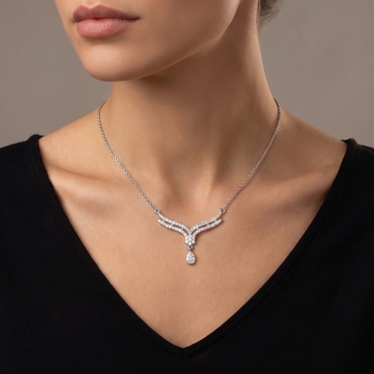 A soft cascade of shimmering curves and delicate brilliance, this necklace captures an elegant flowing silhouette that feels effortlessly graceful. The layered crystal lines and suspended teardrop detail create a refined sparkle designed to elevate every look.