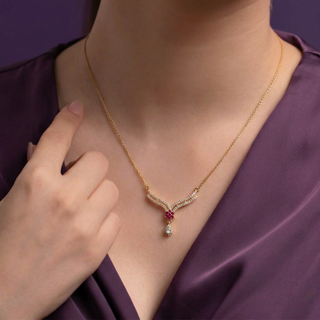 A delicate curve of shimmering crystals paired with a ruby-toned floral center, this necklace brings a graceful sparkle that feels soft, elegant, and effortlessly refined. The dangling crystal drop adds just the right touch of movement for a timeless feminine finish.
