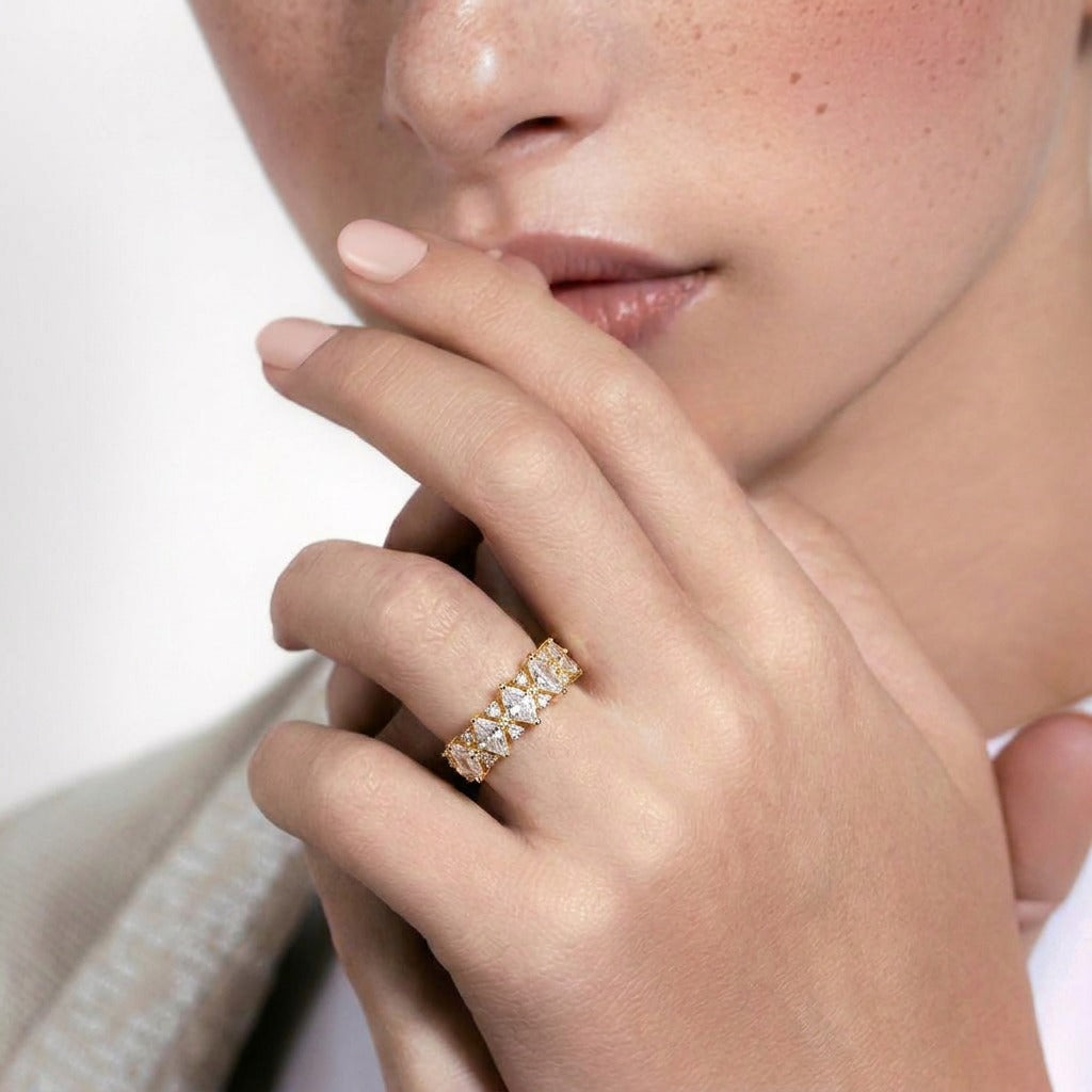 A graceful blend of royal elegance and delicate brilliance, this ring features a row of sparkling square-cut stones framed with intricate lace-like accents. Its refined silhouette creates a crown-inspired charm that feels luxurious, feminine, and timeless.