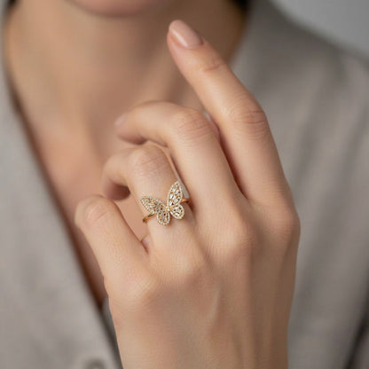 A delicate butterfly frozen in crystal shimmer, this ring captures the beauty of graceful wings touched by light. With its intricate openwork details and sparkling silhouette, it brings a soft yet statement elegance that feels dreamy, feminine, and effortlessly enchanting.