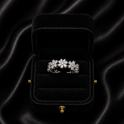 A delicate bloom of shimmering petals, this ring captures the soft elegance of tiny daisies frozen in crystal light. Designed with sparkling floral details and a graceful open silhouette, it brings a dreamy charm that feels both feminine and timeless.