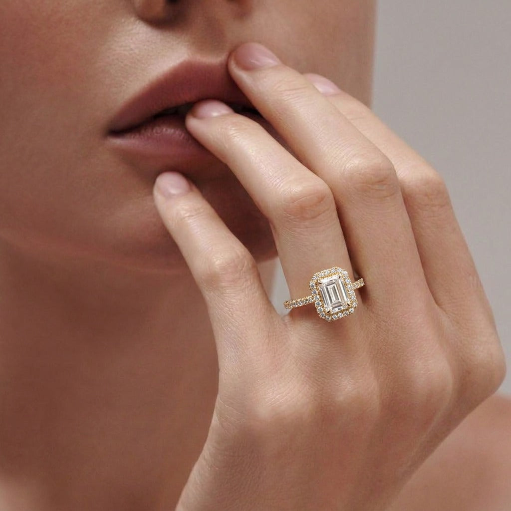 A radiant sparkle framed in timeless elegance, this ring captures the refined beauty of emerald-inspired brilliance with a soft shimmering glow. Featuring a delicate rectangular crystal centerpiece surrounded by sparkling accents, it brings a graceful charm that feels luxurious, modern, and effortlessly sophisticated.