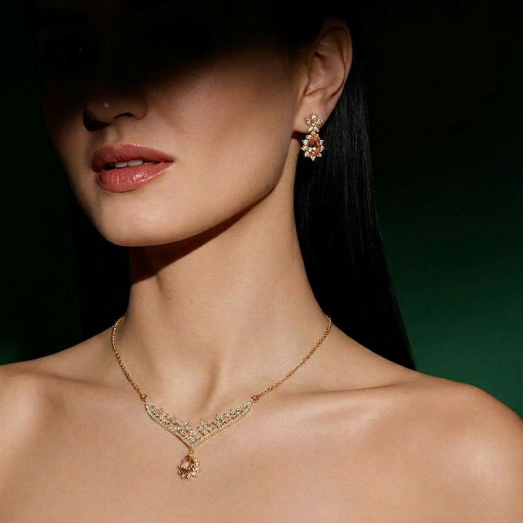 A delicate bloom of crystal flowers and warm champagne-toned stones, this set captures the elegance of a garden kissed by golden light. The floral vine silhouette paired with soft teardrop accents creates a graceful sparkle that feels romantic, refined, and timeless.