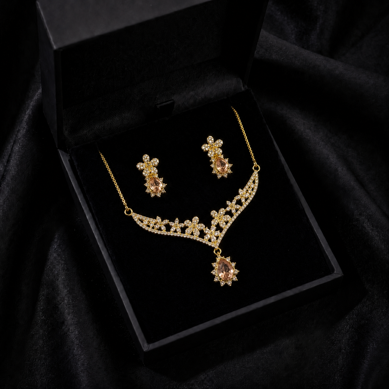 A delicate bloom of crystal flowers and warm champagne-toned stones, this set captures the elegance of a garden kissed by golden light. The floral vine silhouette paired with soft teardrop accents creates a graceful sparkle that feels romantic, refined, and timeless.