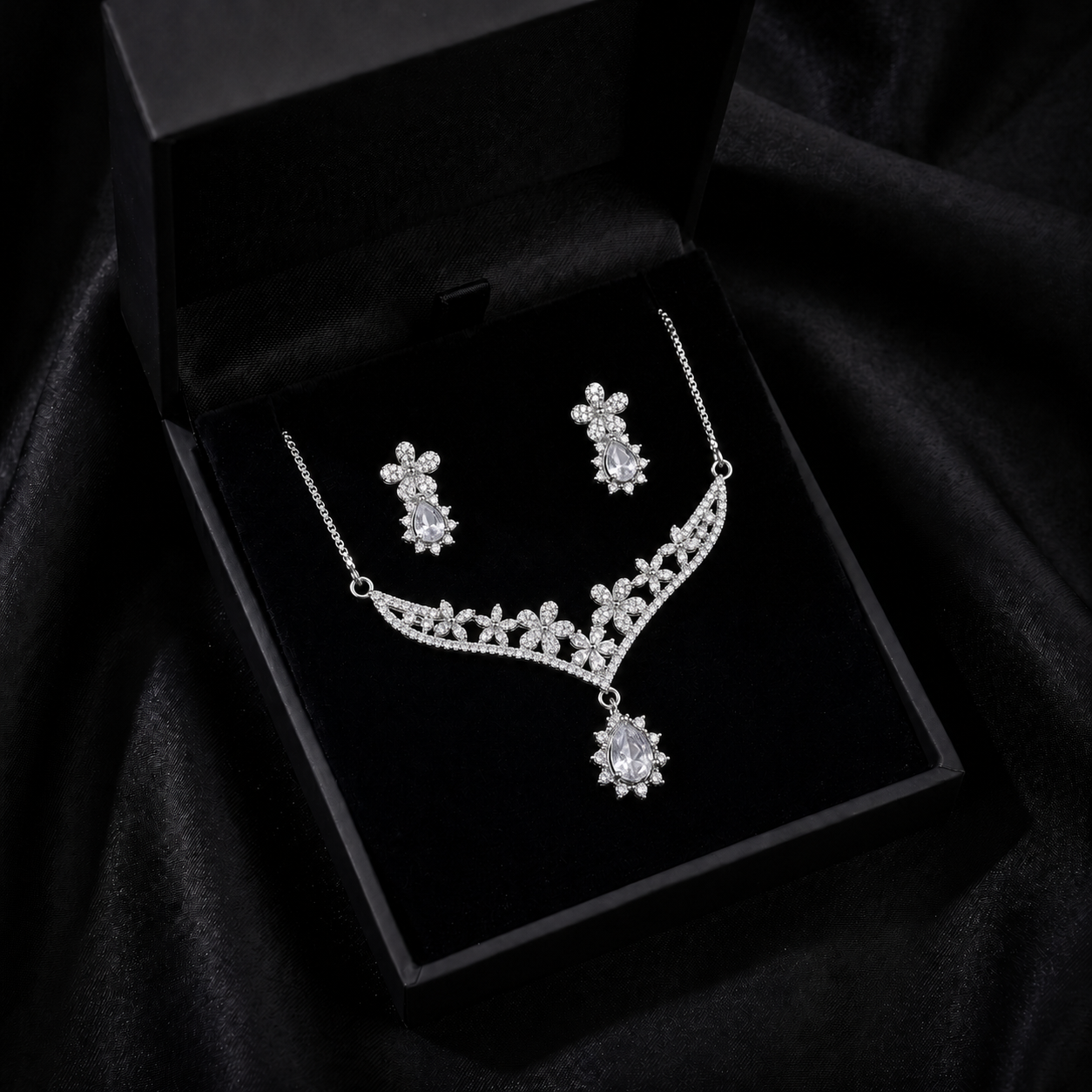 A delicate bloom of crystal flowers and warm champagne-toned stones, this set captures the elegance of a garden kissed by golden light. The floral vine silhouette paired with soft teardrop accents creates a graceful sparkle that feels romantic, refined, and timeless.