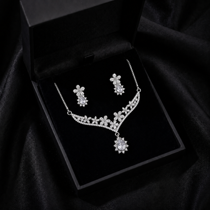 A delicate bloom of crystal flowers and warm champagne-toned stones, this set captures the elegance of a garden kissed by golden light. The floral vine silhouette paired with soft teardrop accents creates a graceful sparkle that feels romantic, refined, and timeless.