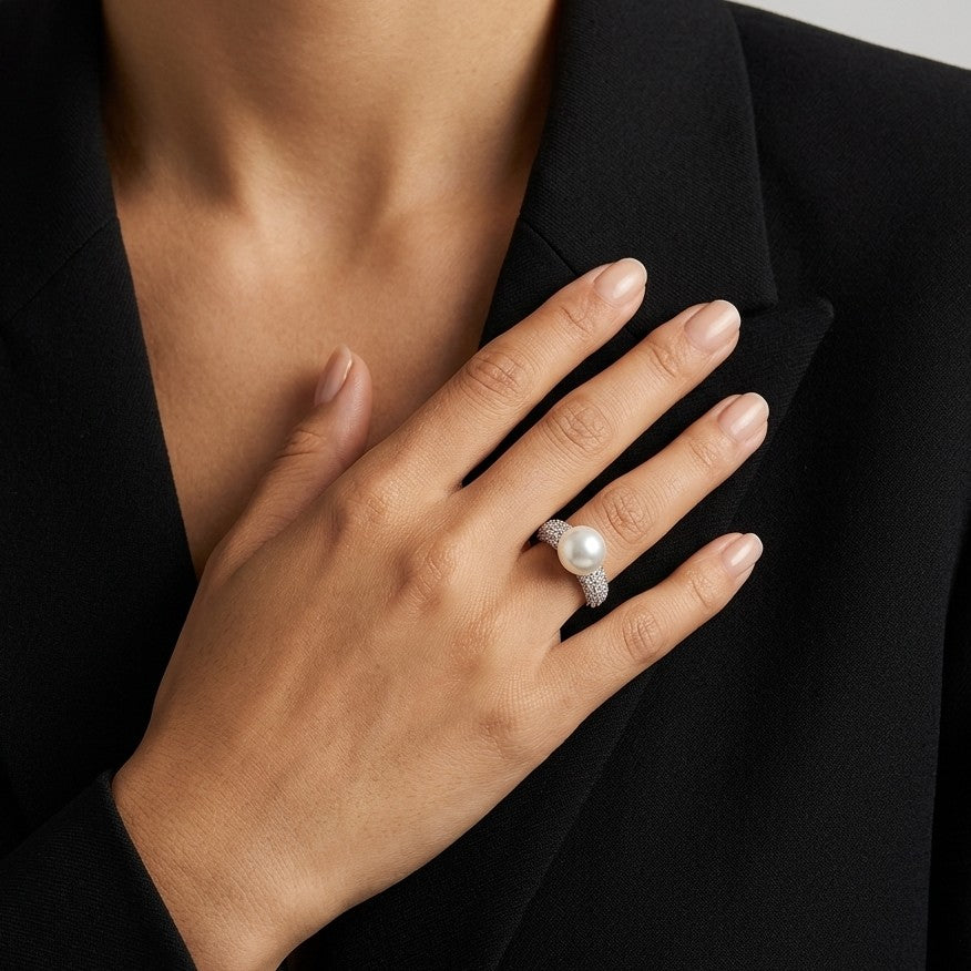Unveil the essence of goddess-like beauty with the Glacial Crown Ring. This enchanting piece features a majestic center pearl cradled by intricate silver-toned petals, capturing the spirit of a frozen bloom for a look that is both regal and timeless.