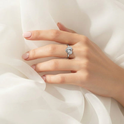 A symbol of love wrapped in radiant elegance, this ring features a sparkling heart-cut centerpiece embraced by a delicate halo of brilliance. Its graceful silhouette and romantic charm create a timeless piece that feels both heartfelt and luxurious.