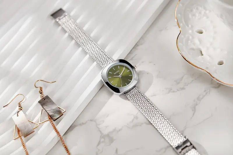 Designed for effortless everyday style, the Lume Classic Watch features a refined sunray dial with slim pointer markers, framed in a polished square case and finished with a stainless-steel mesh strap that drapes beautifully on the wrist. Minimal, feminine, and timeless.