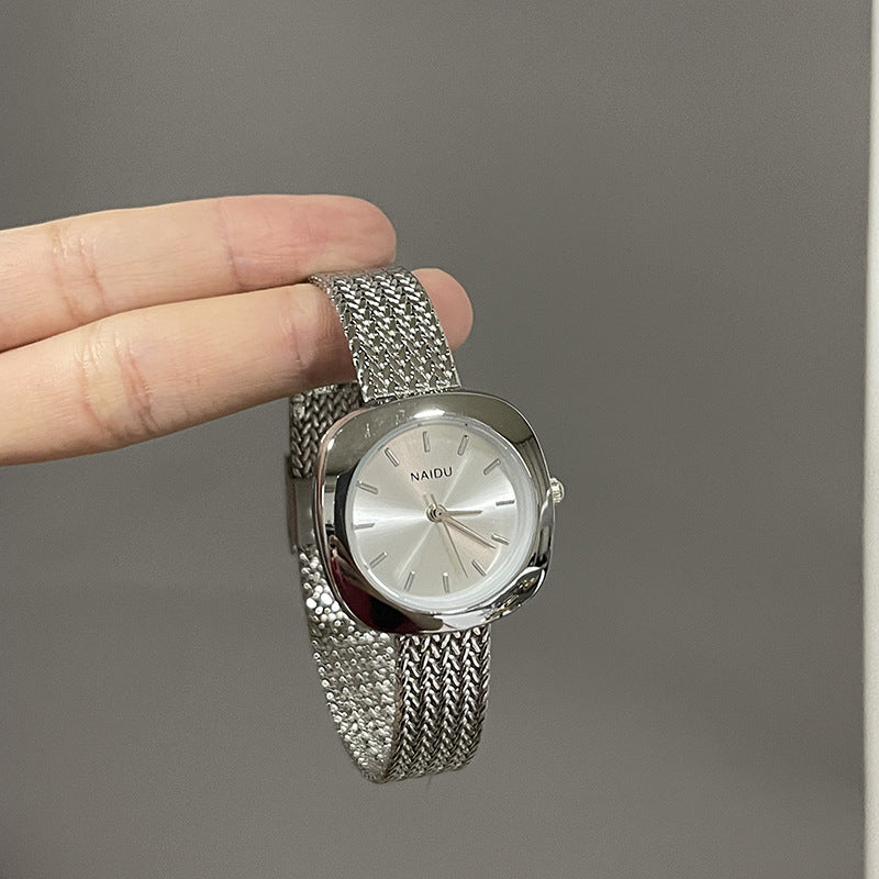 Designed for effortless everyday style, the Lume Classic Watch features a refined sunray dial with slim pointer markers, framed in a polished square case and finished with a stainless-steel mesh strap that drapes beautifully on the wrist. Minimal, feminine, and timeless.