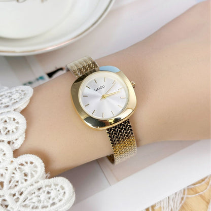 Designed for effortless everyday style, the Lume Classic Watch features a refined sunray dial with slim pointer markers, framed in a polished square case and finished with a stainless-steel mesh strap that drapes beautifully on the wrist. Minimal, feminine, and timeless.