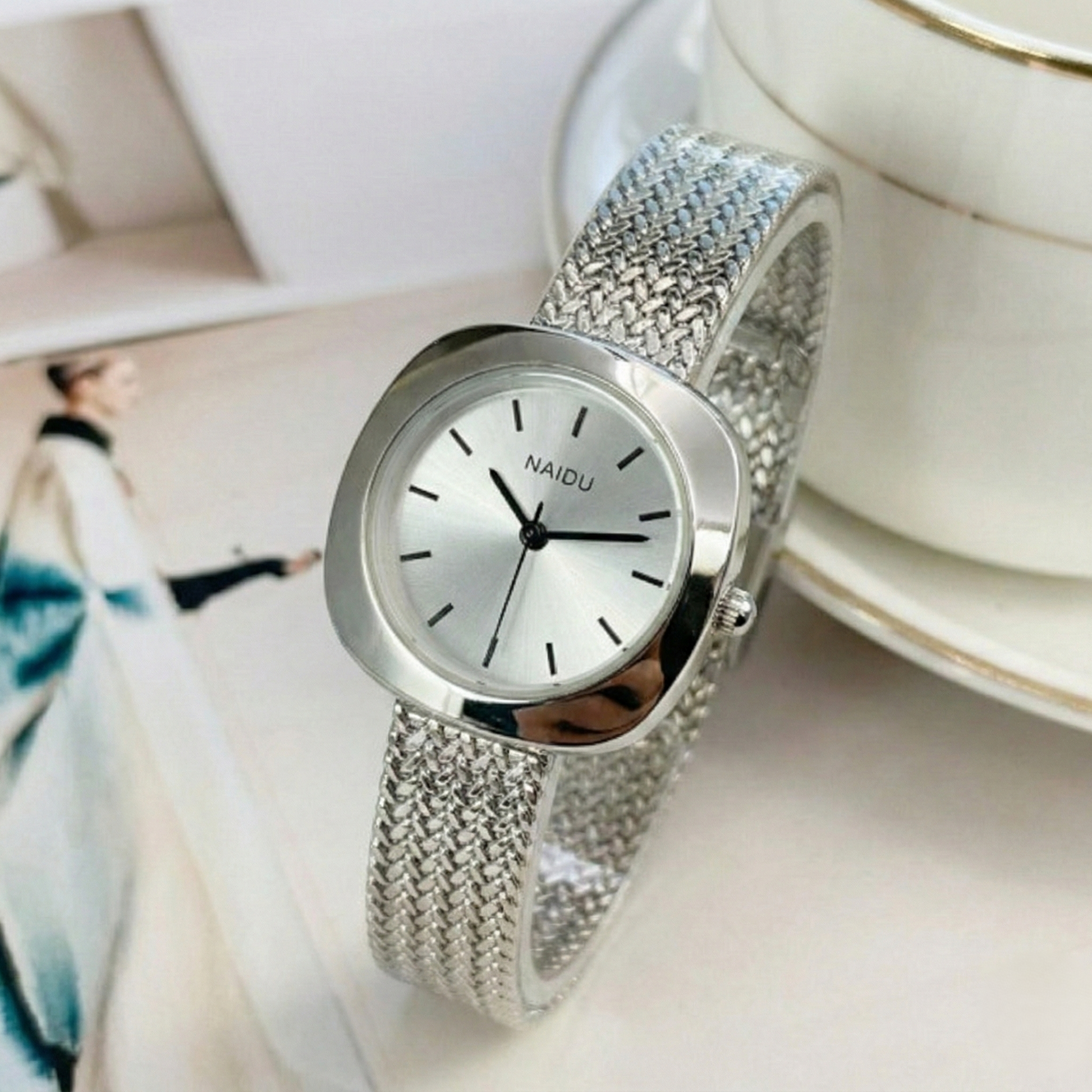 Designed for effortless everyday style, the Lume Classic Watch features a refined sunray dial with slim pointer markers, framed in a polished square case and finished with a stainless-steel mesh strap that drapes beautifully on the wrist. Minimal, feminine, and timeless.