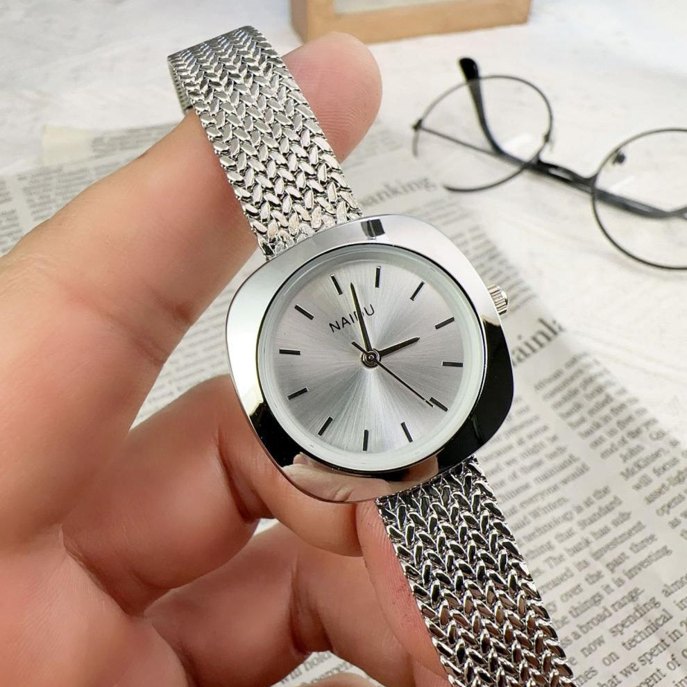 Designed for effortless everyday style, the Lume Classic Watch features a refined sunray dial with slim pointer markers, framed in a polished square case and finished with a stainless-steel mesh strap that drapes beautifully on the wrist. Minimal, feminine, and timeless.