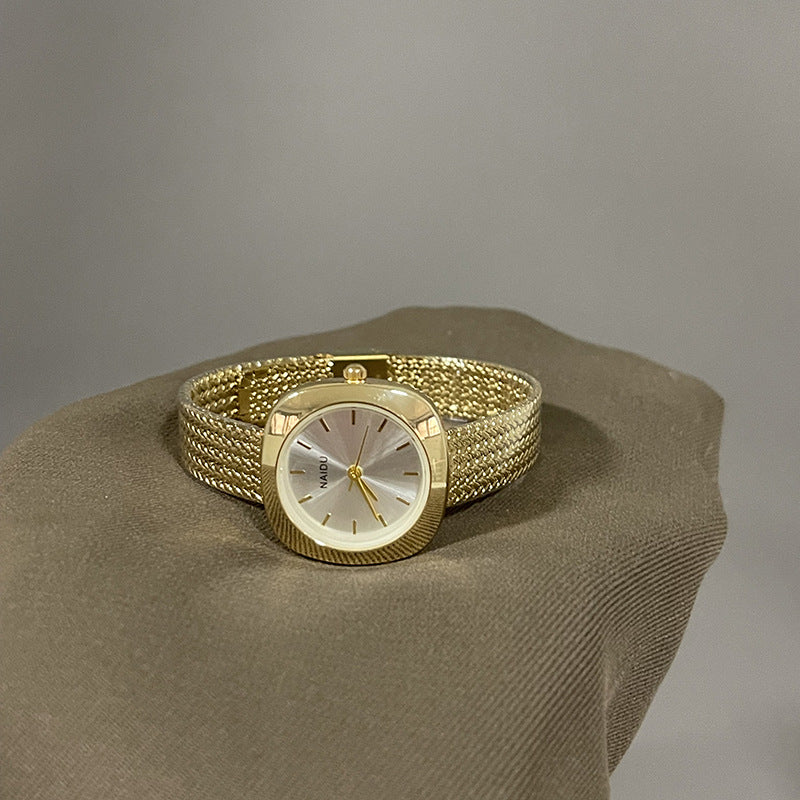 Designed for effortless everyday style, the Lume Classic Watch features a refined sunray dial with slim pointer markers, framed in a polished square case and finished with a stainless-steel mesh strap that drapes beautifully on the wrist. Minimal, feminine, and timeless.