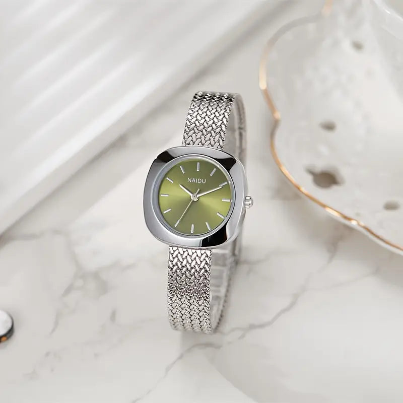 Designed for effortless everyday style, the Lume Classic Watch features a refined sunray dial with slim pointer markers, framed in a polished square case and finished with a stainless-steel mesh strap that drapes beautifully on the wrist. Minimal, feminine, and timeless.