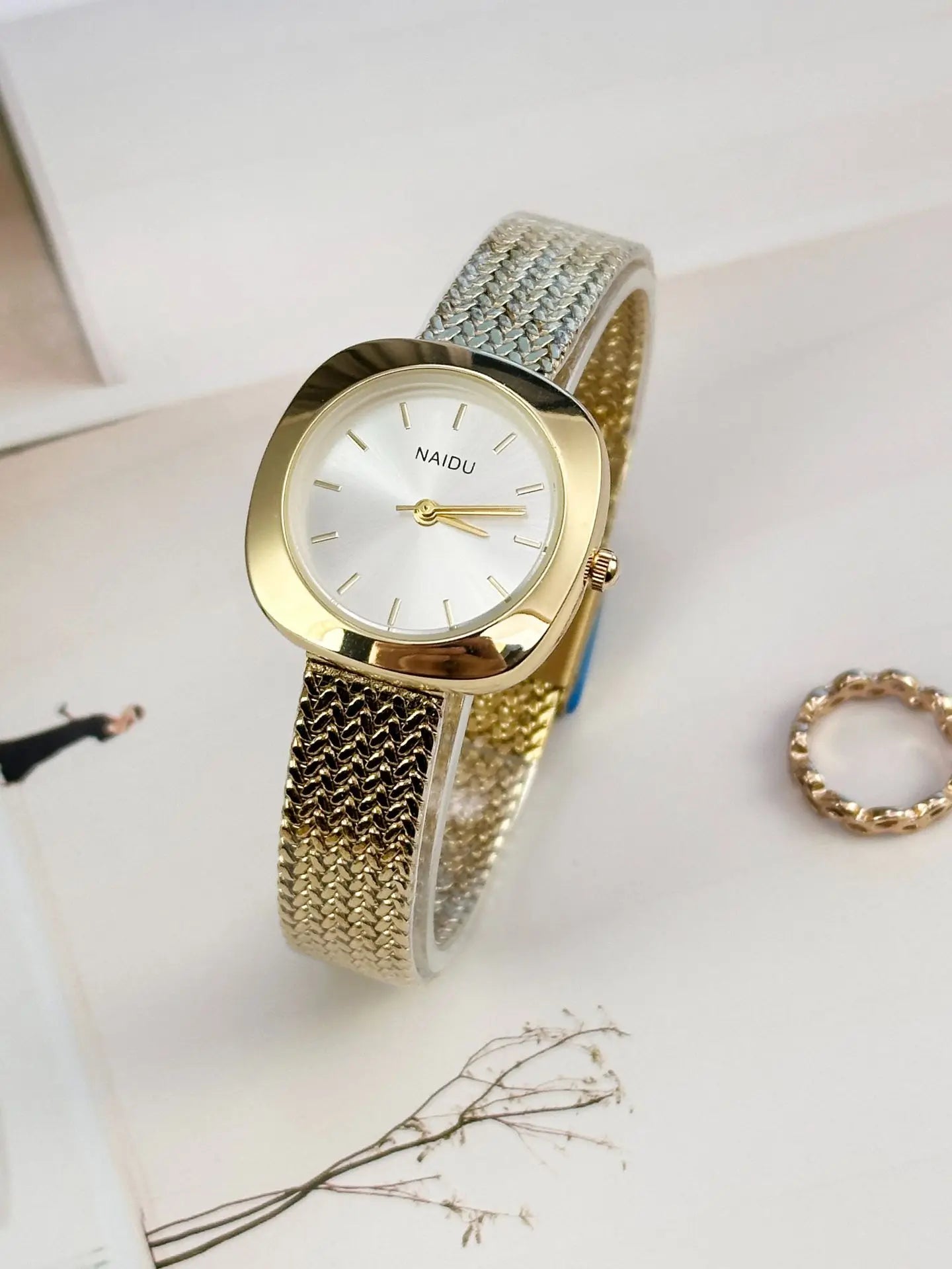 Designed for effortless everyday style, the Lume Classic Watch features a refined sunray dial with slim pointer markers, framed in a polished square case and finished with a stainless-steel mesh strap that drapes beautifully on the wrist. Minimal, feminine, and timeless.