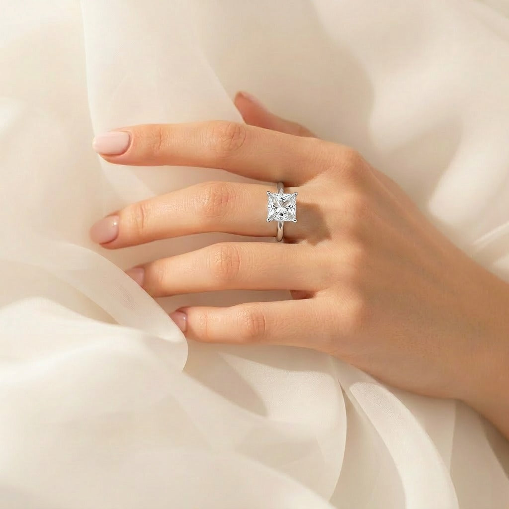 A radiant statement crafted to steal every glance, this ring captures the beauty of crystal-clear brilliance with its bold prism-cut centerpiece and sleek minimal band. Its luminous sparkle creates a luxurious yet timeless look that feels effortlessly elegant.