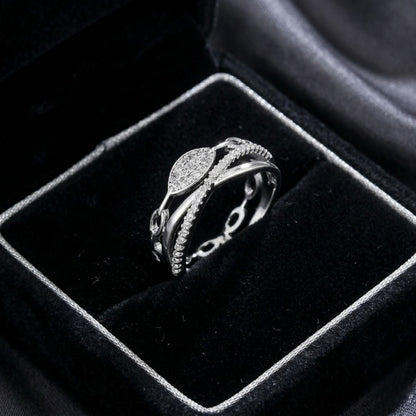 The Lustre Loop Ring features a beautifully intertwined design that blends modern elegance with delicate brilliance. Accented with shimmering zircon stones and a sleek looped structure, this ring creates a flowing silhouette that feels both refined and eye-catching. The unique loop design symbolizes continuity and elegance. Available exclusively at Loftique your One Stop Gifting Solution.