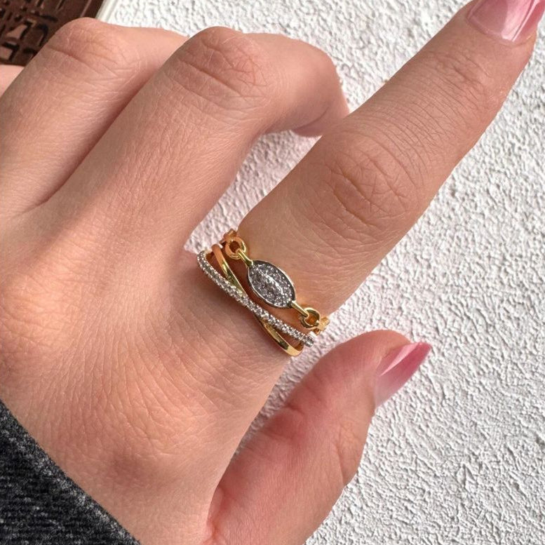The Lustre Loop Ring features a beautifully intertwined design that blends modern elegance with delicate brilliance. Accented with shimmering zircon stones and a sleek looped structure, this ring creates a flowing silhouette that feels both refined and eye-catching. The unique loop design symbolizes continuity and elegance. Available exclusively at Loftique your One Stop Gifting Solution.