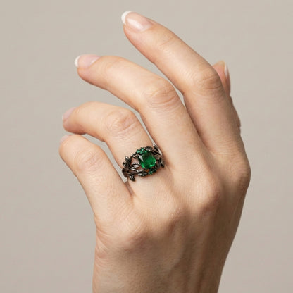 The Midnight Ivy Ring is a lush creation rooted in gothic romance and dark enchantment. A deep green crystal glows at the center, crowned by intricate vines and leaf motifs that wrap the finger like a secret from an ancient forest.