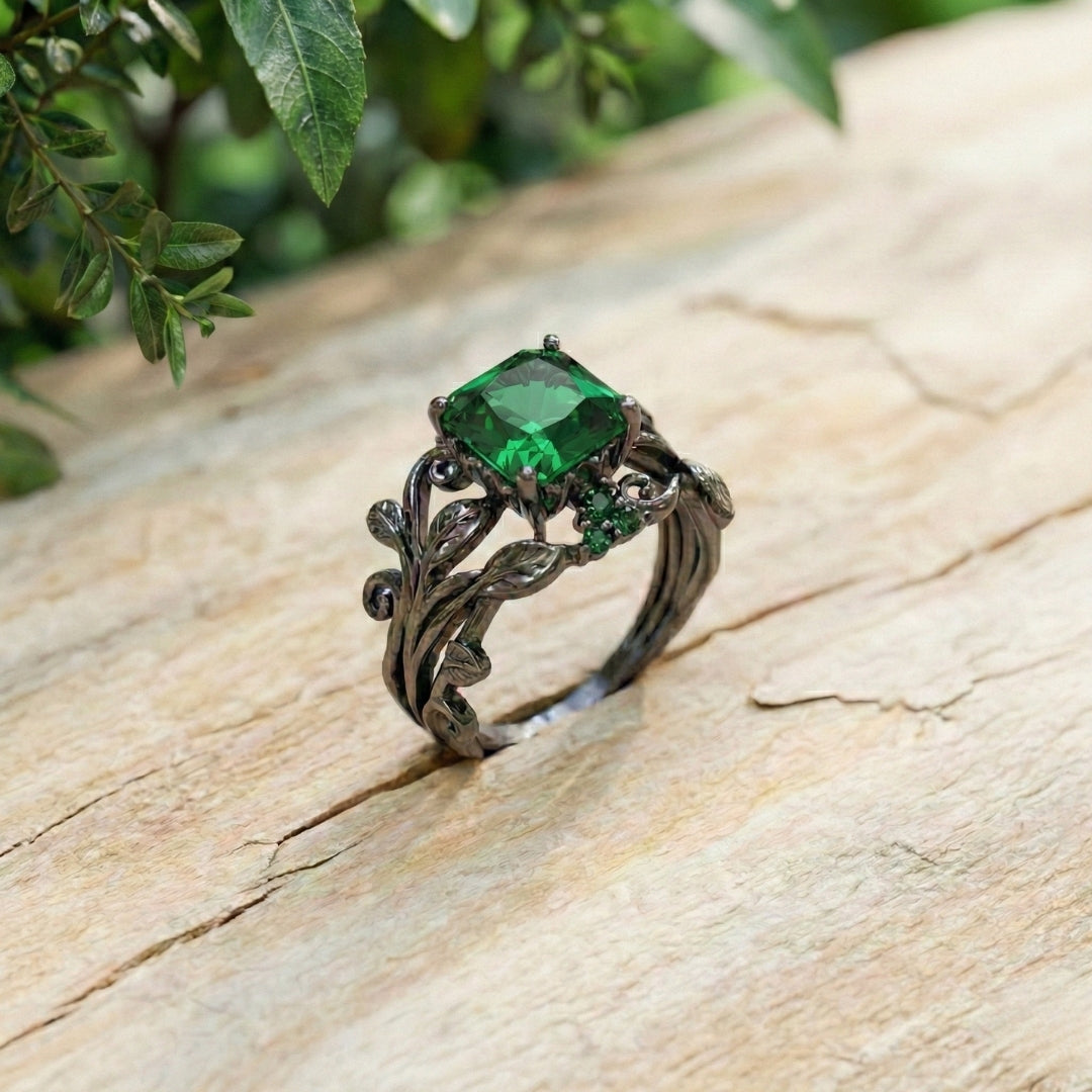 The Midnight Ivy Ring is a lush creation rooted in gothic romance and dark enchantment. A deep green crystal glows at the center, crowned by intricate vines and leaf motifs that wrap the finger like a secret from an ancient forest.