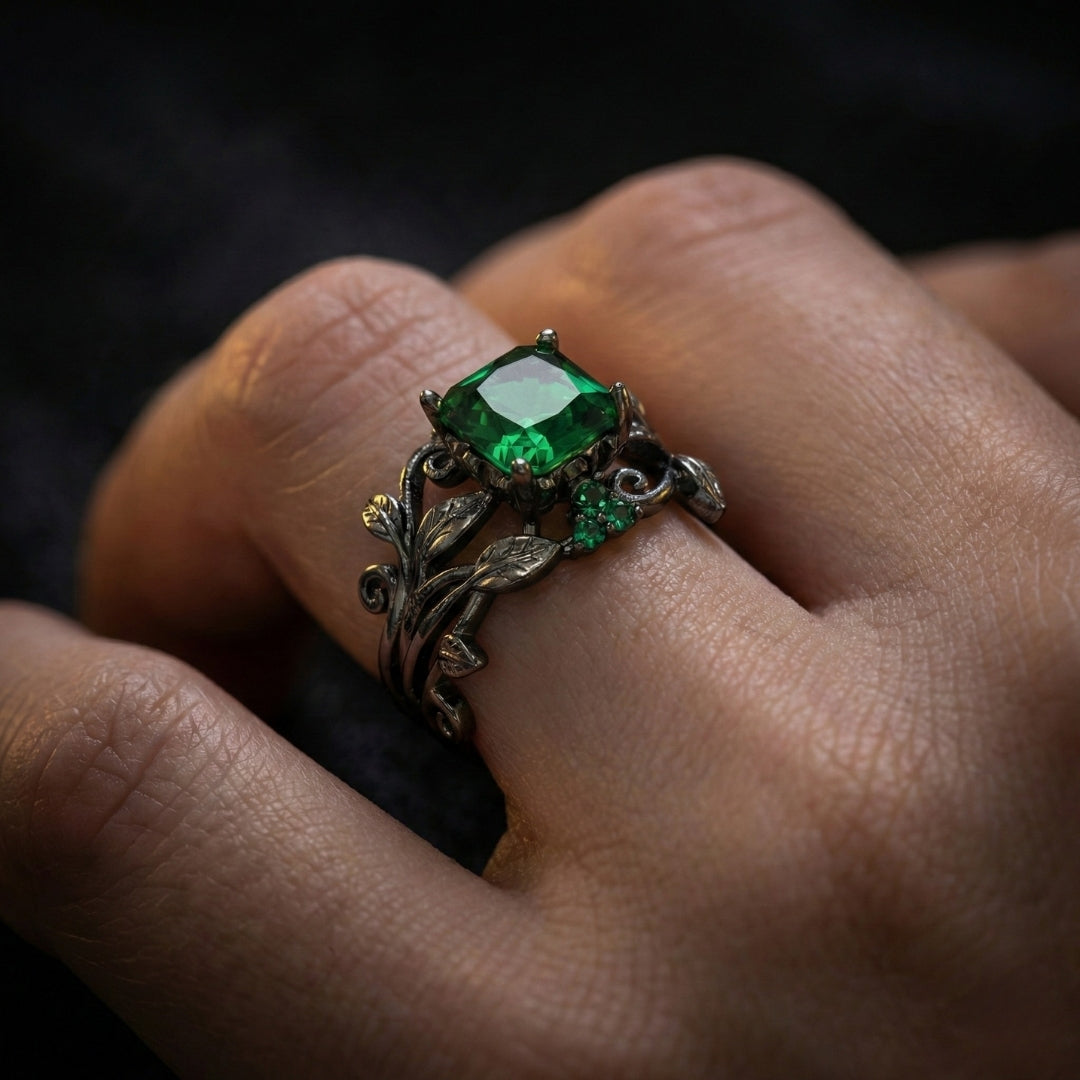 The Midnight Ivy Ring is a lush creation rooted in gothic romance and dark enchantment. A deep green crystal glows at the center, crowned by intricate vines and leaf motifs that wrap the finger like a secret from an ancient forest.