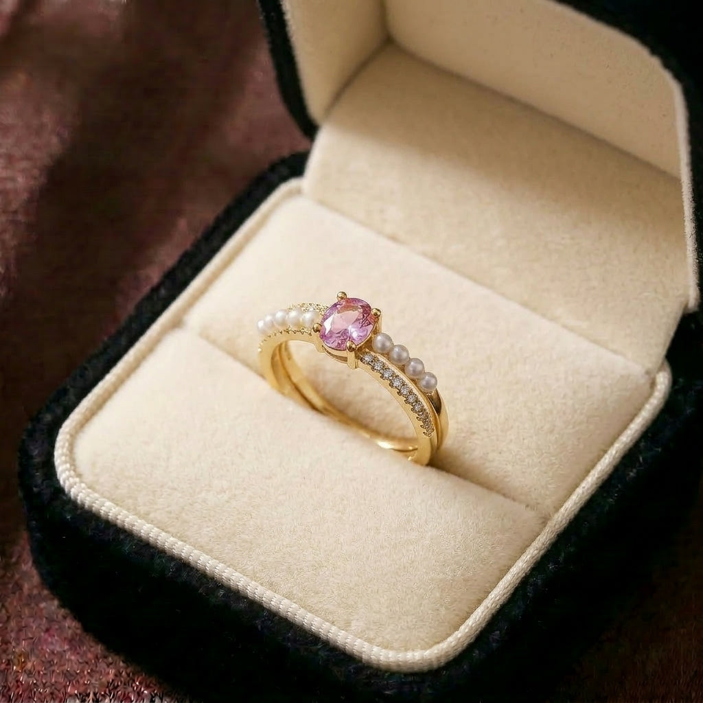 A delicate harmony of blush sparkle and pearl elegance, this ring features a soft pink gemstone embraced by luminous pearl accents and a crystal-lined band. Its graceful silhouette creates a dreamy statement that feels romantic, feminine, and effortlessly elegant.