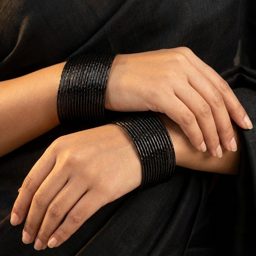A soft cascade of textured shine, the Raindrop Kangan captures the delicate rhythm of falling droplets in every curve. Each bangle reflects light with a subtle shimmer, creating a fluid, layered look that feels both graceful and bold at once.