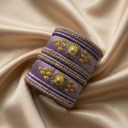 Crafted with rich silk thread and adorned with intricate golden embellishments, the Reshmi Bangles bring a bold festive charm to your look. Each stack carries a unique handcrafted touch making every piece slightly different, yet equally stunning.