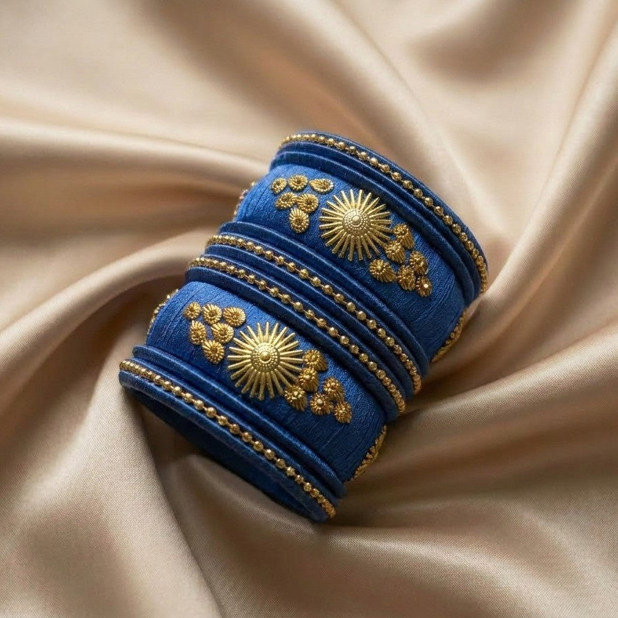 Crafted with rich silk thread and adorned with intricate golden embellishments, the Reshmi Bangles bring a bold festive charm to your look. Each stack carries a unique handcrafted touch making every piece slightly different, yet equally stunning.