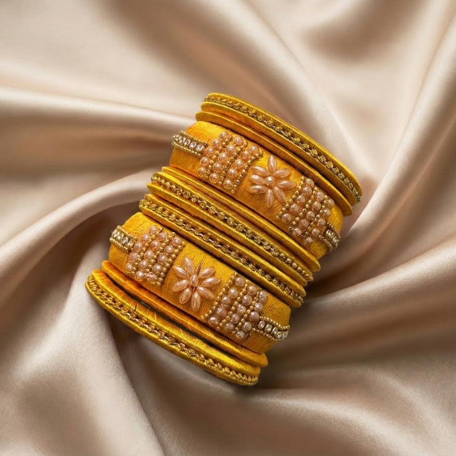 Crafted with rich silk thread and adorned with intricate golden embellishments, the Reshmi Bangles bring a bold festive charm to your look. Each stack carries a unique handcrafted touch — making every piece slightly different, yet equally stunning.