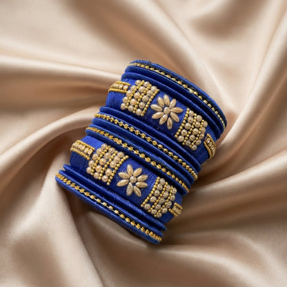 Crafted with rich silk thread and adorned with intricate golden embellishments, the Reshmi Bangles bring a bold festive charm to your look. Each stack carries a unique handcrafted touch — making every piece slightly different, yet equally stunning.