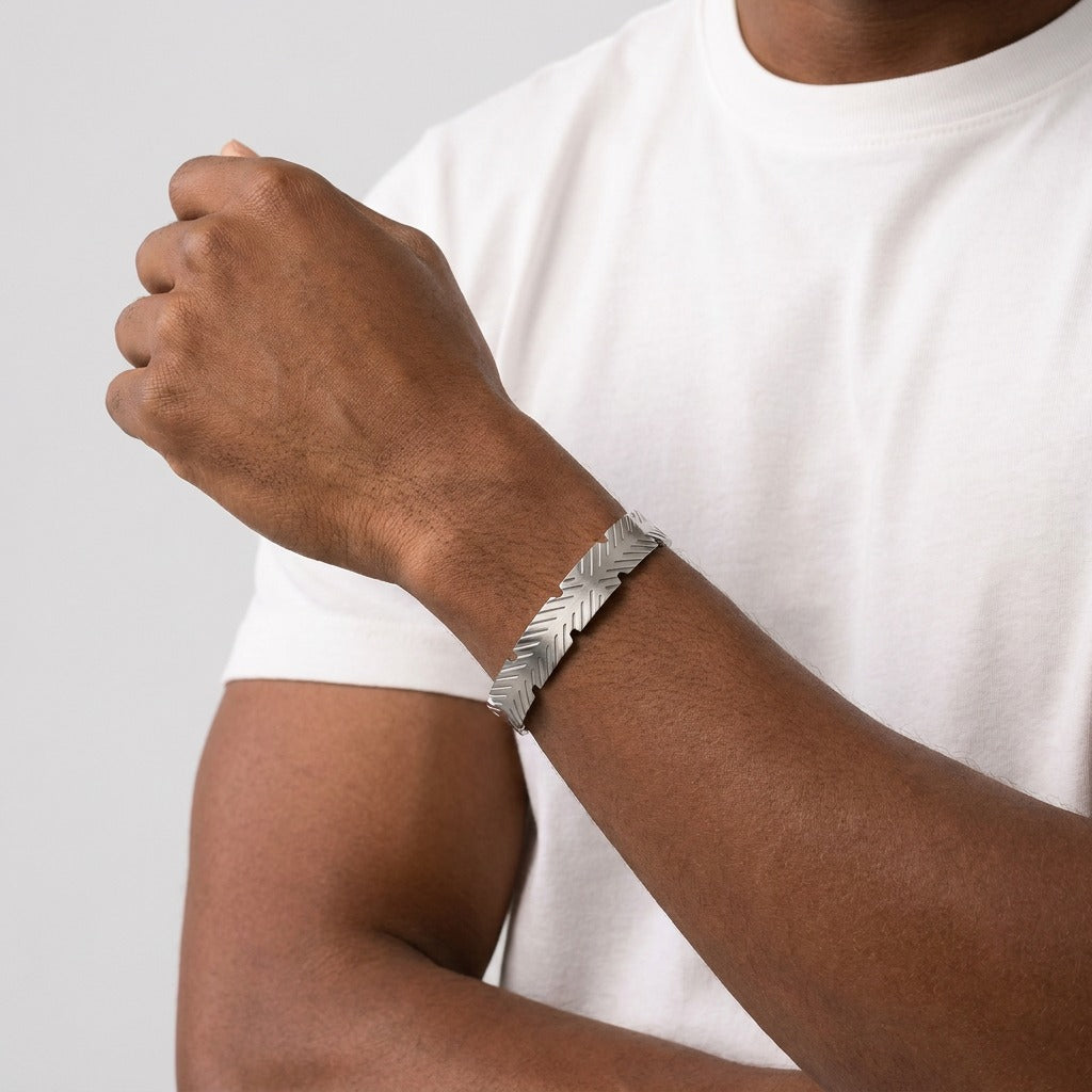 A sharp expression of modern style, this cuff features clean geometric cuts that create a bold, edgy look. Its structured design and sleek finish give off a confident, urban vibe—perfect for those who like their accessories minimal yet striking.