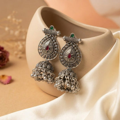 A bold expression of strength wrapped in elegance, this piece blends intricate craftsmanship with a powerful, heritage-inspired silhouette. The teardrop centerpiece paired with detailed engraving and cascading ghungroo drops creates a striking movement that feels both fierce and beautifully refined.