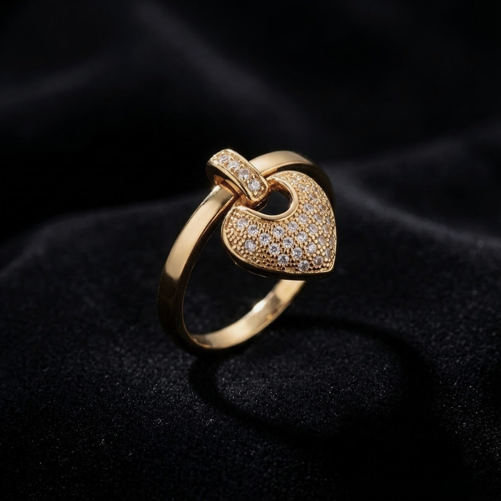 A romantic statement ring defined by a delicate hanging heart silhouette, softly paved with shimmering zircon stones. The Velmora Heart Ring is designed to capture love in motion graceful, expressive, and full of feeling. Its suspended heart detail adds gentle movement, making the design feel alive, emotional, and irresistibly charming.